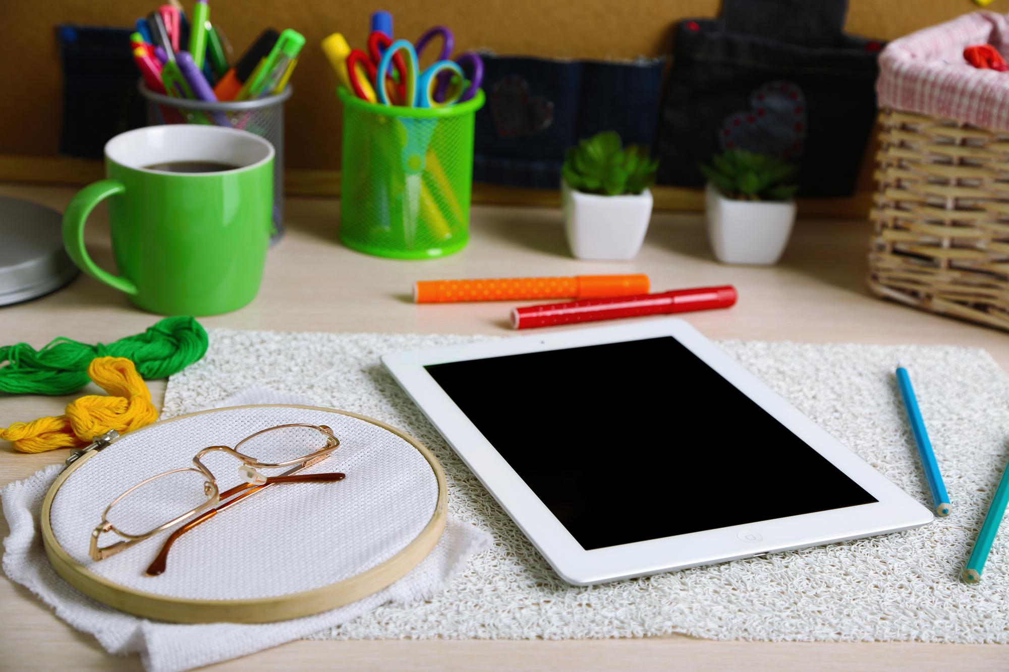 studio table with threads, hoops and digitizing tablet