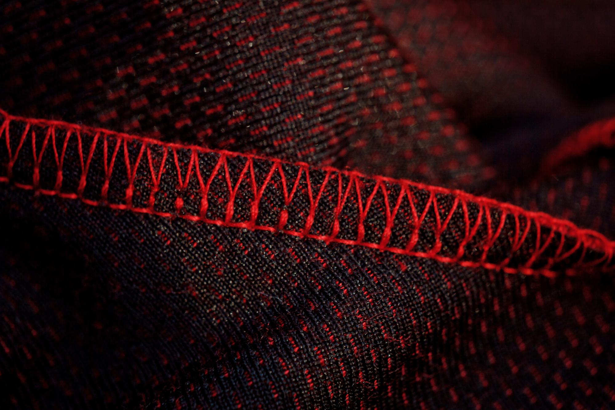 close-up of embroidered dark fabric with high-contrast threads